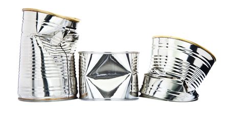 Three damaged tin cans isolated against a white background.  DOF is from front to back (everything in focus).の写真素材