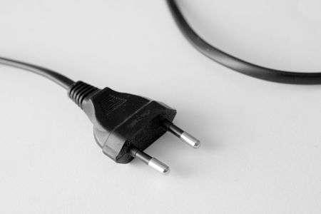 plug of electricity on white bottom