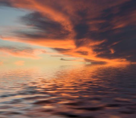 Red evening clouds with reflectionの写真素材