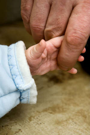 The small child keeping for a finger of the fatherの写真素材