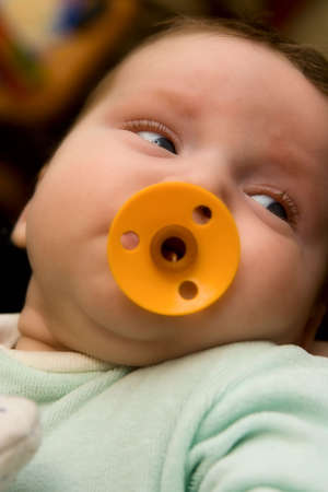 The small baby with a dummy in a mouthの写真素材