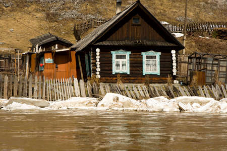 Old house on coast of the spread riverの写真素材