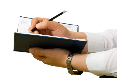 Hand writing to a notebook. Close up.