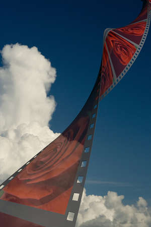 Film with roses on a background of the cloudy skyの写真素材