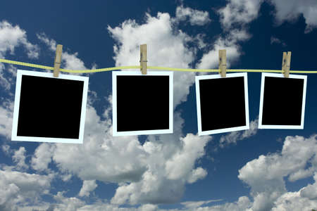 Four clean photos hanging on a cord. 3D image.の写真素材