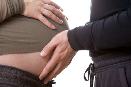 Stomach of the pregnant woman on white background