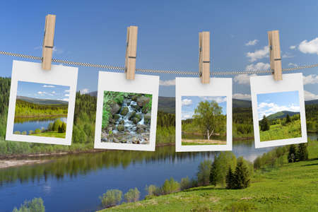 Landscape photographs hanging on clothesline. 3D imageの写真素材