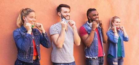 Multiracial millennial friends smiling with face mask - Students on travel vacation