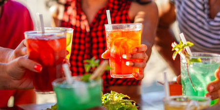 Happy people cheering with mojito and having fun - Multiracial friends drinking coktails in a beach...