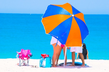 Colourful beach umbrella on white sand beachの素材