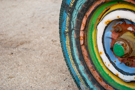 multi-colored trailer wheel, tractor, on the background of sand, road rusty bolts,の写真素材