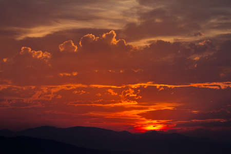 Colorful cloud patterns with golden hour light.の写真素材