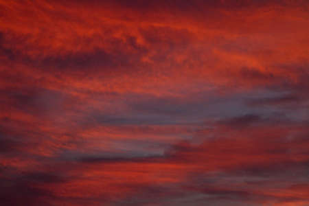 Colorful cloud patterns with golden hour light.の写真素材