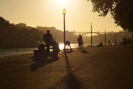Porto, Portugal; Aug. 02, 2012. Streets of the city of Porto in summer. People fishing in the river Dueroのeditorial素材