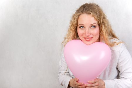 The girl has control over a ball and smiles. の写真素材