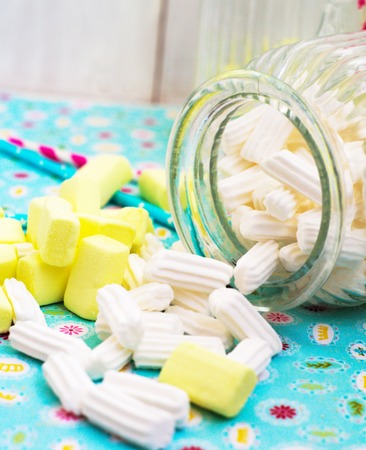    yellow and white marshmallow with glass jug                            の写真素材