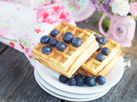 Belgian waffles with blueberries on the wooden rustic surfaceの写真素材