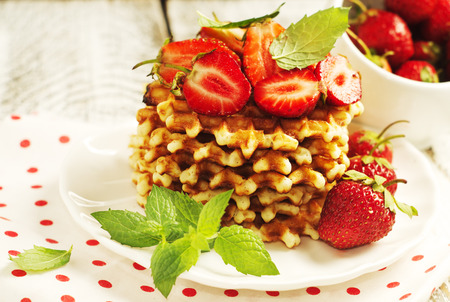 French waffles with strawberries and leaves of mint. Selective focusの写真素材