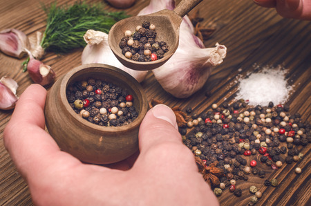 Man cook holding a spoon full of peas pepper. Preparation of ingredients.の写真素材