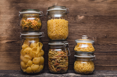 Pasta macaroni concept background. Pasta in a glass jar container.の写真素材