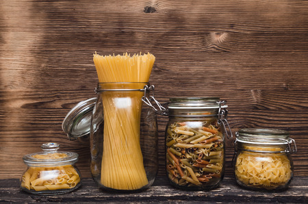 Pasta macaroni concept background. Pasta in a glass jar container.の写真素材
