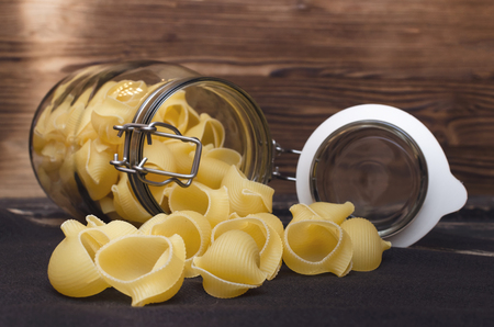 Pasta macaroni concept background. Pasta in a glass jar container.の写真素材