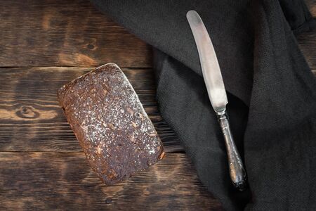Freshly baked bread on a wooden table background.