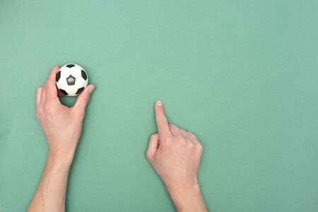 Football ball on a green field flat lay background with copy space. Game plan template.の写真素材