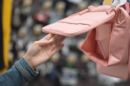 Student girl choosing a new backpack in a store.の写真素材