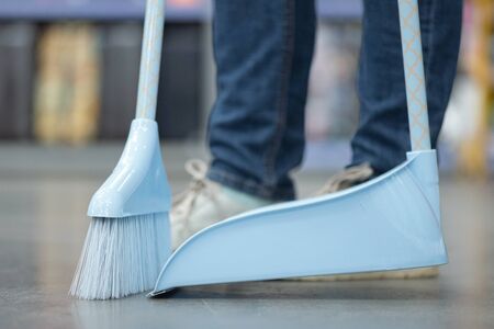 Cleaner sweeping the floor with a brush.の写真素材