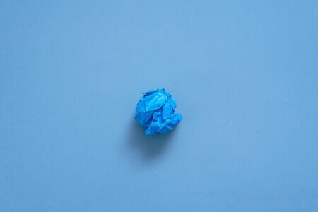 Crumpled colorful paper pages on blue background.の写真素材