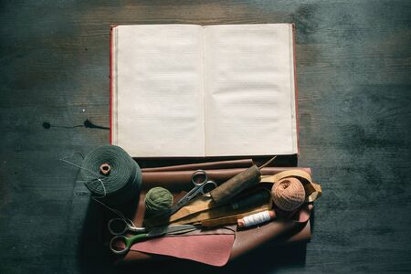Old sewing accessory flat lay background. Sewing handbook template.の写真素材