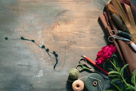 Old sewing accessory flat lay background.