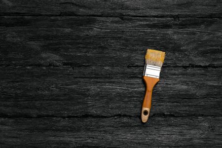 Paint brush on black wooden board flat lay background with a copy space.の写真素材