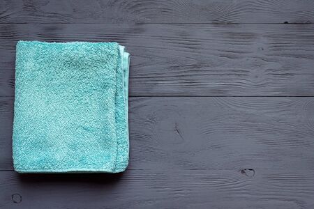 Bath towel on gray wooden background with a copy space. Hygiene flat lay background.の写真素材