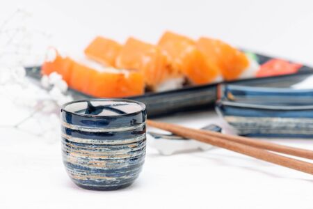 Sake drink on a sushi rolls background.の写真素材