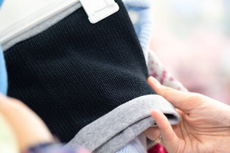 Woman is choosing a new clothes in a store close up.の写真素材