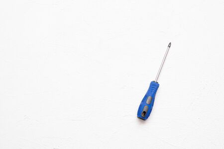 Screwdriver with blue handle on a white flat lay background with copy space.の写真素材