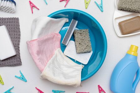 Hand wash concept. Wash basin, towel, detergent, soap, pin and brush on white background with copy...