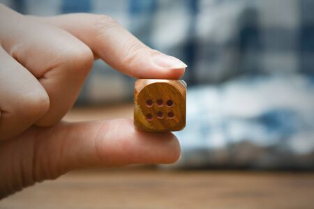 The dice in female hand close up.