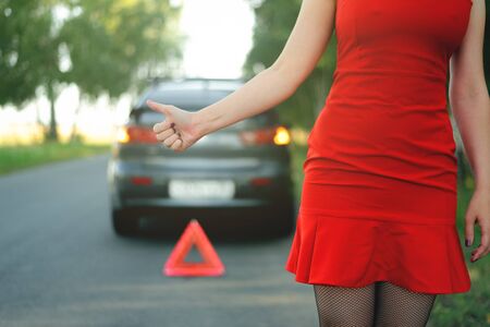 Woman needs help with a broken car.の写真素材