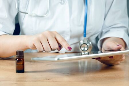 Doctor working on her tablet computer.の写真素材