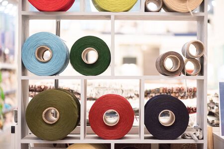 Sewing rope reels on a store shelf close up background.の写真素材