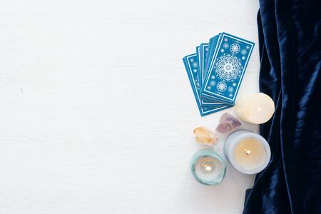Tarot cards on the white wooden table background.の写真素材