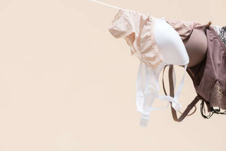 Female underwear is hanging on the rope on light background.の写真素材