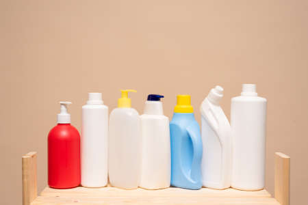 Various detergent bottles on the store counter on the light background with copy space.の写真素材