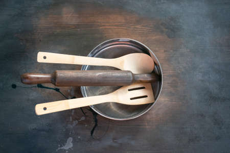 Rolling pin, sieve and scapula on the wooden kitchen table background.の写真素材