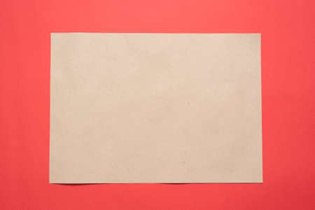 Blank paper page with copy space on the red flat lay background.
