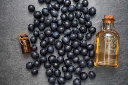 Grapes and grape essential oil juice on the gray table background with copy space.の写真素材