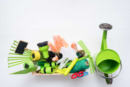 Gardening equipment on the white flat lay background with copy space.